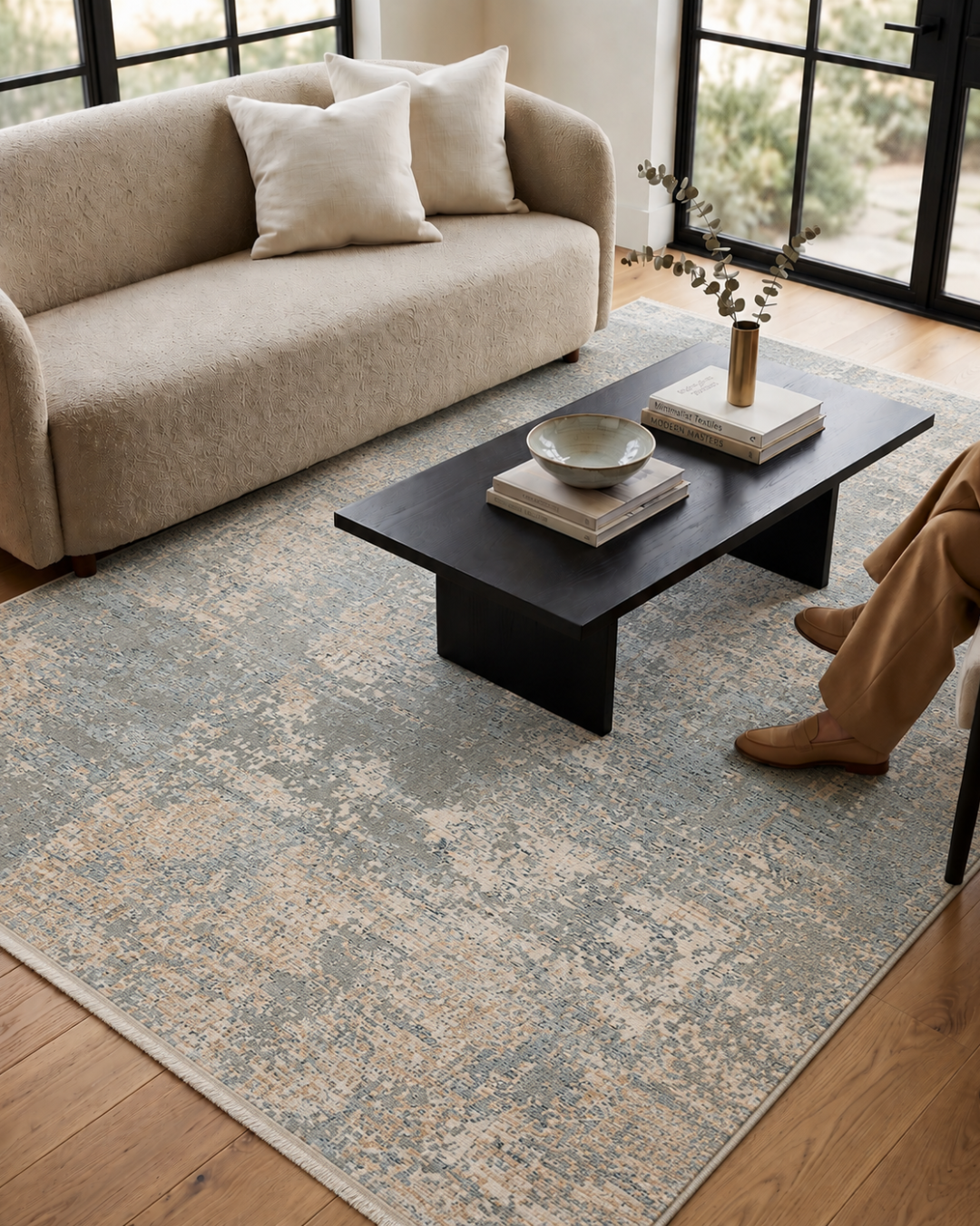 Dalyn Rugs Regal RG6 Granite Style Shot — Granite blue and beige distressed area rug styled beneath a black coffee table.