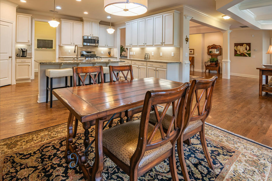 Classic dining room featuring a wooden table, chairs, and a gourmet kitchen setup.