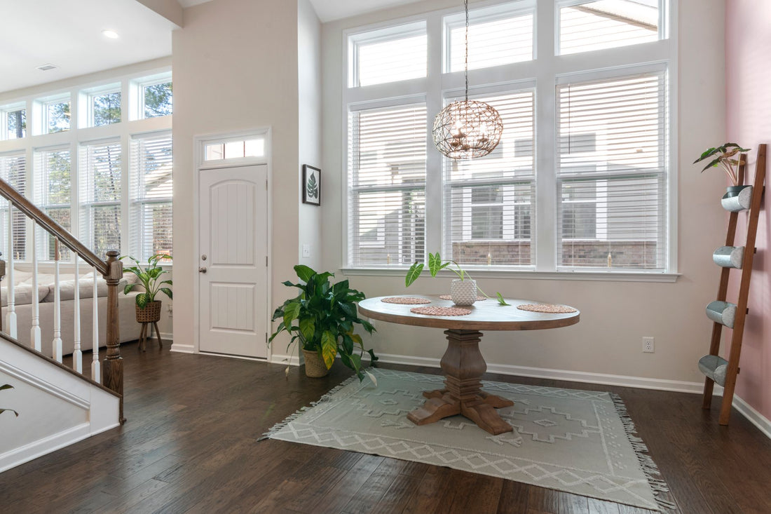 Spacious dining room with minimalist decor, large windows, and natural light.
