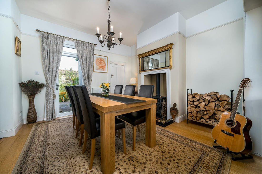 Beautifully designed dining room featuring classic furniture and a guitar by the fireplace.