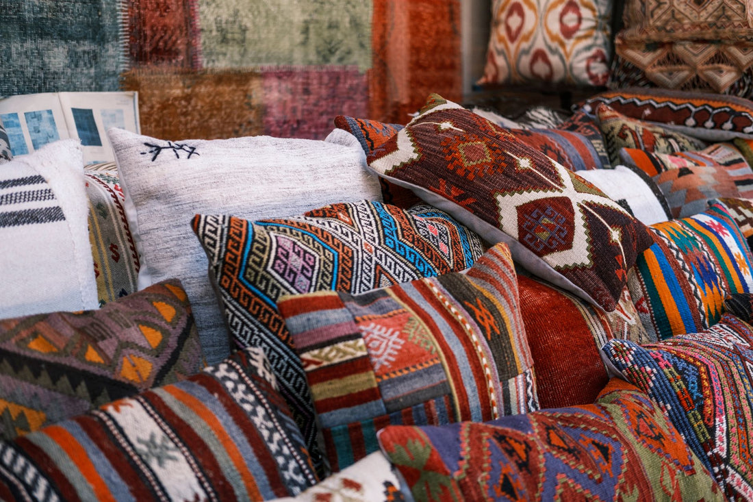 A vibrant collection of multi-colored kilim pillows showcasing intricate textile patterns and rich cultural designs.