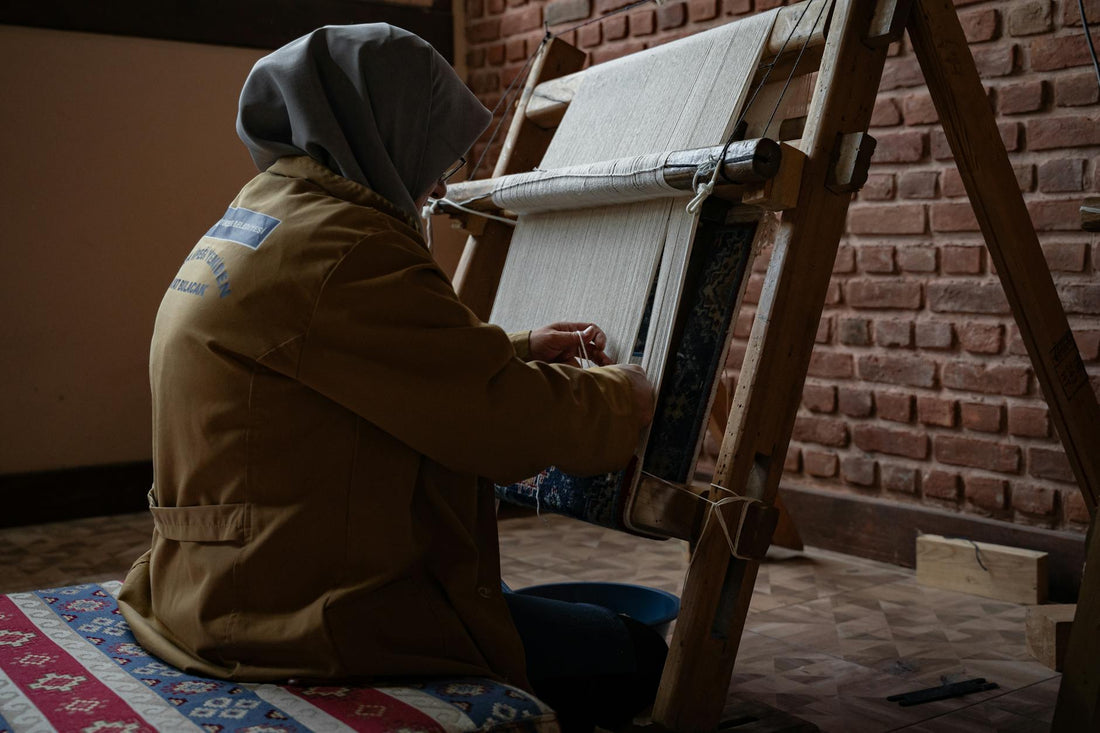 Skilled artisan weaving in a traditional Bursa workshop, showcasing manual work craftsmanship.