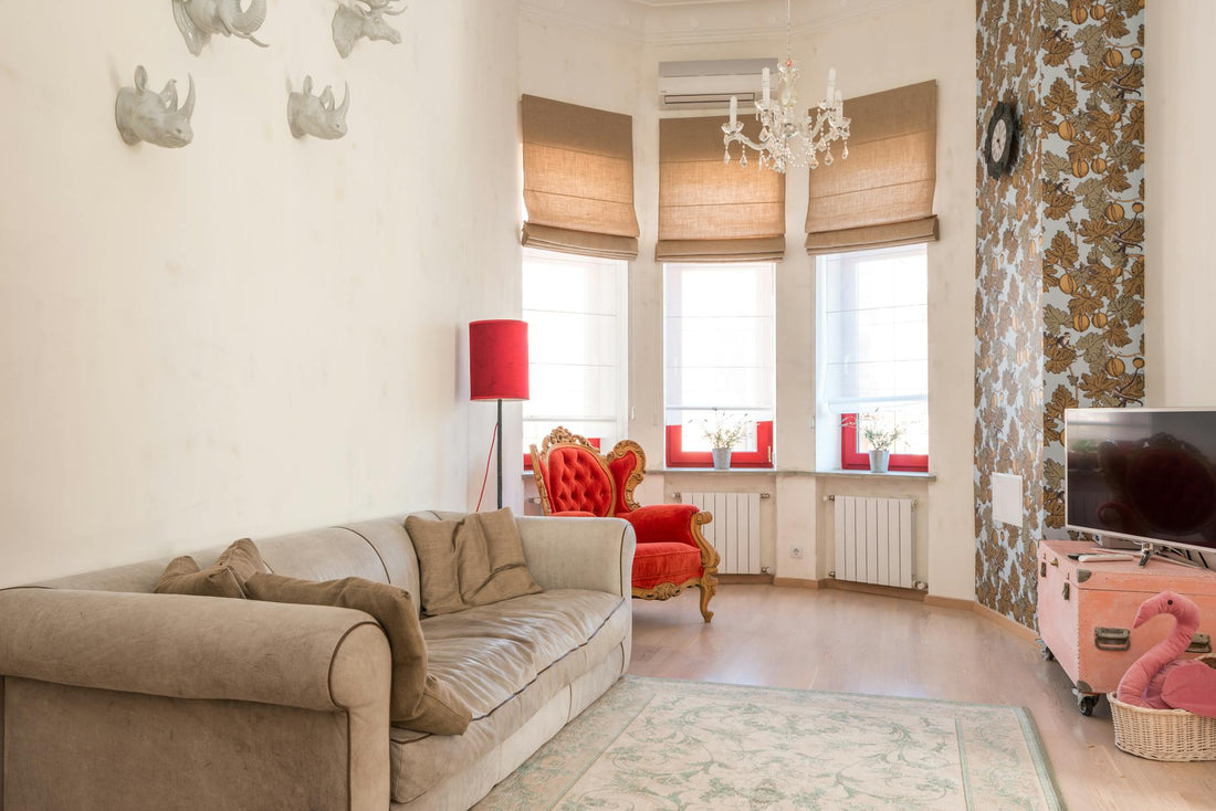 Stylish living room with a plush sofa, red armchair, and ornate decor elements.