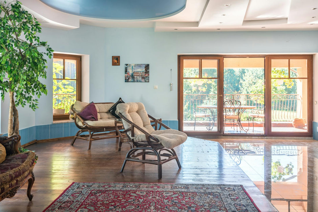 Spacious living room with modern interior and view of sunlit garden balcony.