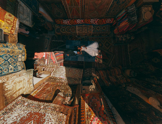 Stunning aerial shot of a newlywed couple on vibrant carpets in Göreme, Turkey.