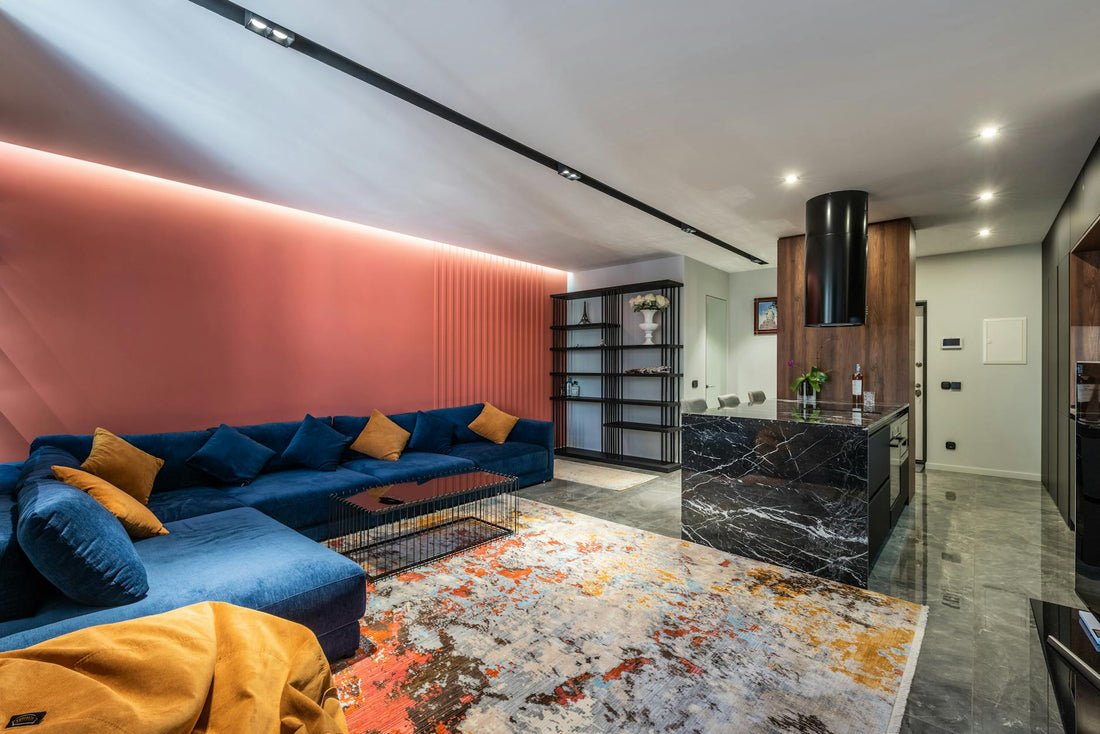 Contemporary living room and kitchen interior with sofa and tables on carpet with abstract ornament in light house