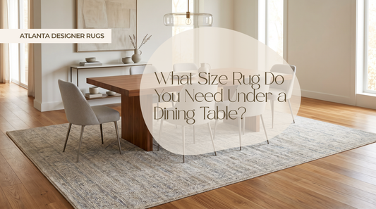 Rug size under dining table guide shown in a luxury dining room with a properly sized designer rug and chairs fully supported on the rug