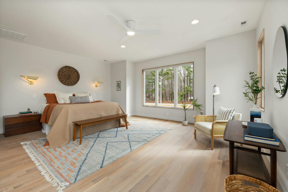 Bright and spacious bedroom with modern decor and large window view.