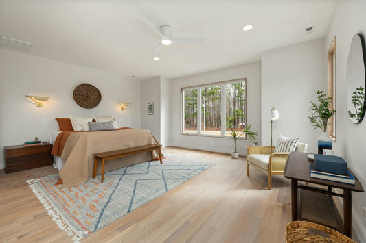 Bright and spacious bedroom with modern decor and large window view.