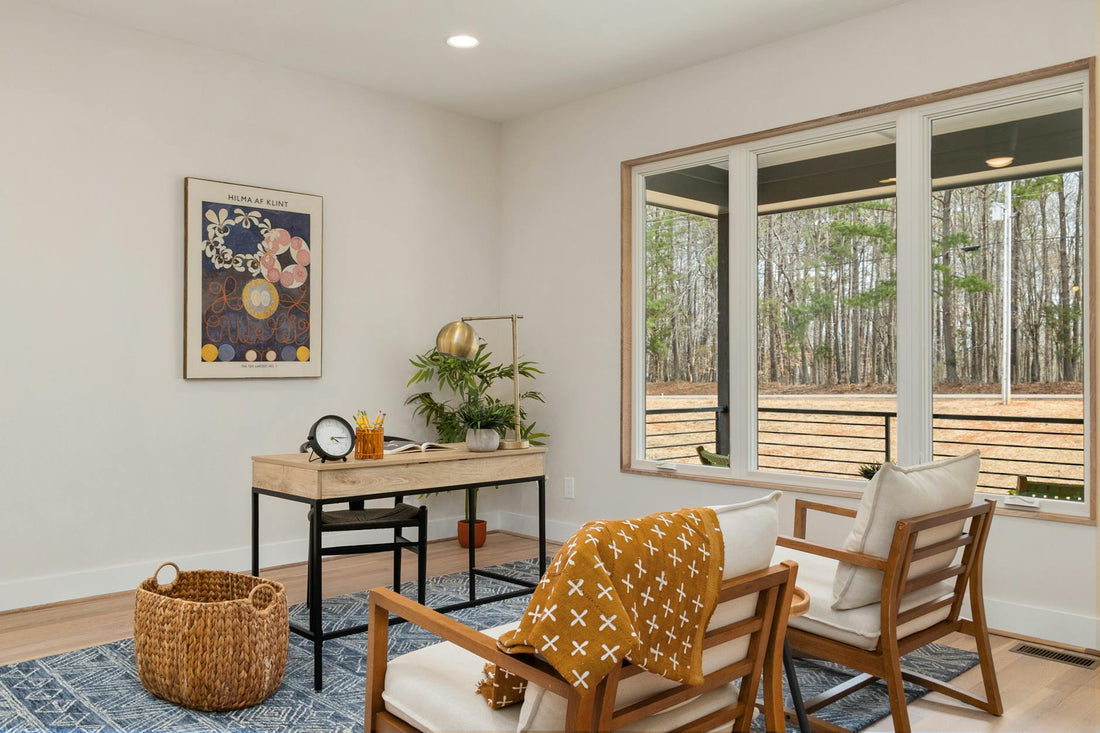Stylish home office with a scenic view, cozy seating, and natural decor.