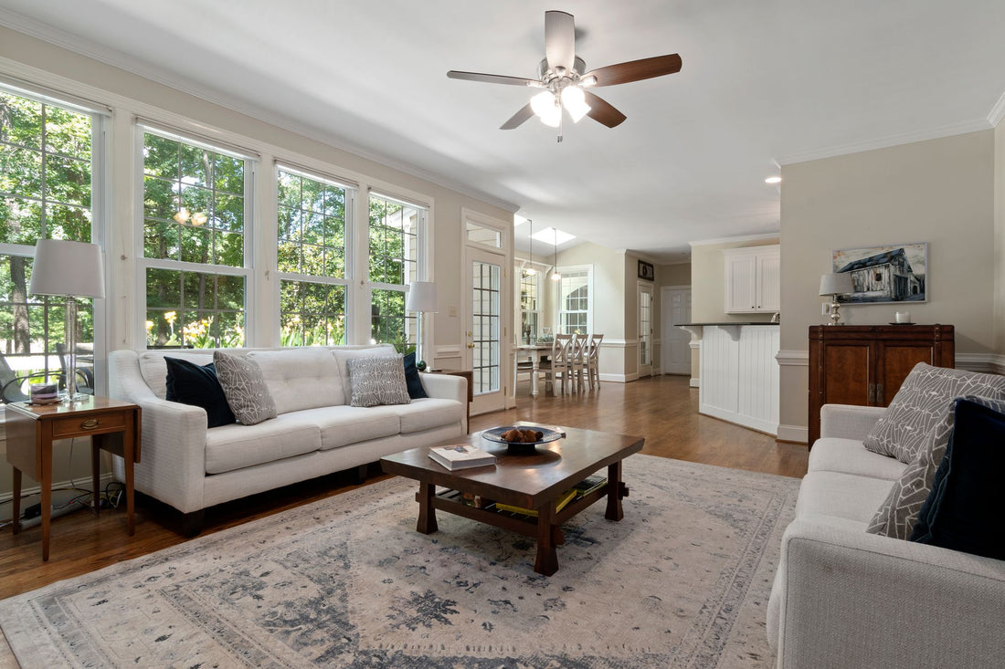 Bright and spacious living room with modern furnishings and large windows letting in natural light.