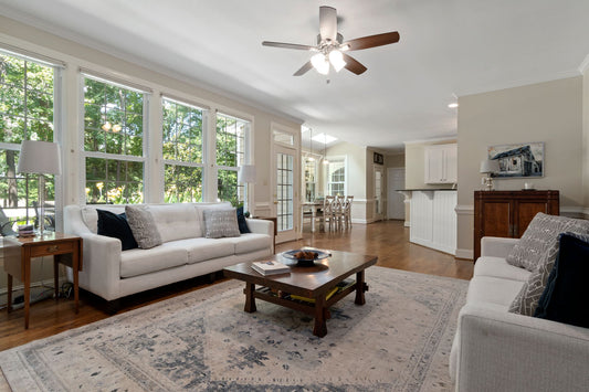 Bright and spacious living room with modern furnishings and large windows letting in natural light.