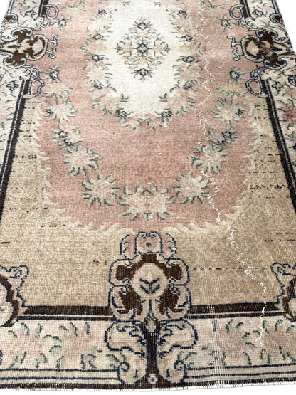 Corner detail of the Artisan Angelina Lt. Gold rug showing authentic vintage distressing
