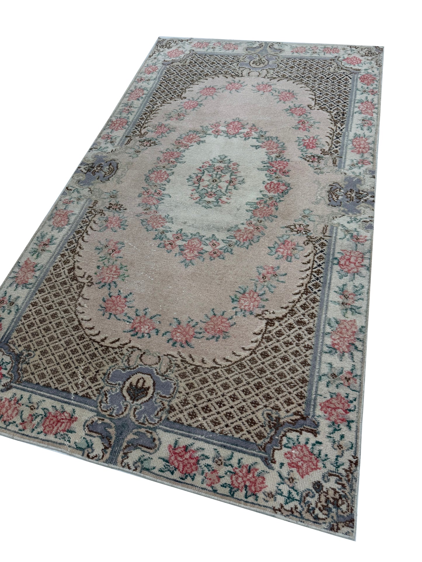 Close-up detail of the hand-knotted wool texture on the Artisan Angelina Coral rug