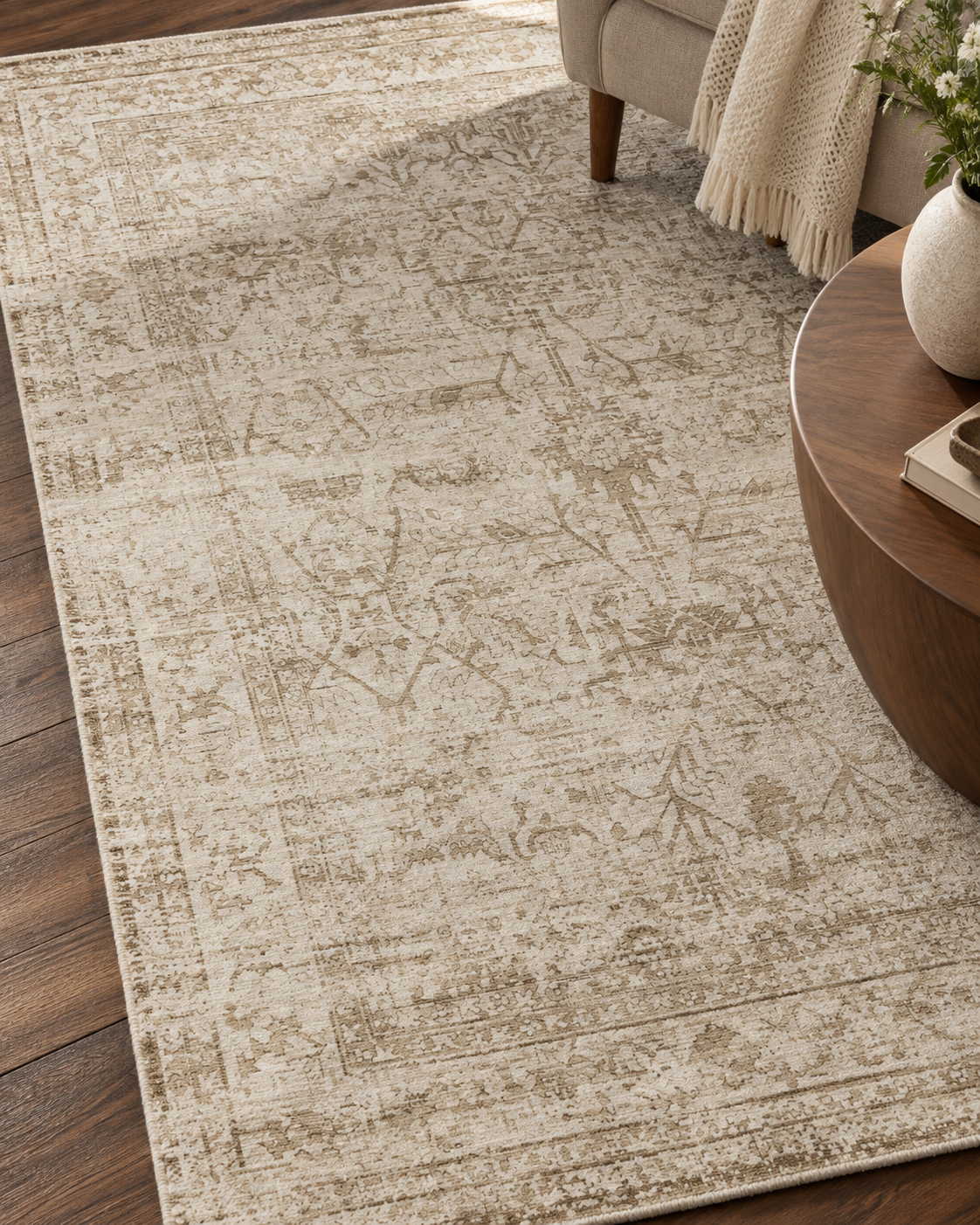 Amber Lewis x Loloi Honora HON-01 Ivory Natural Style Shot — Ivory and natural floral rug detail beside a neutral sofa and wooden coffee table.
