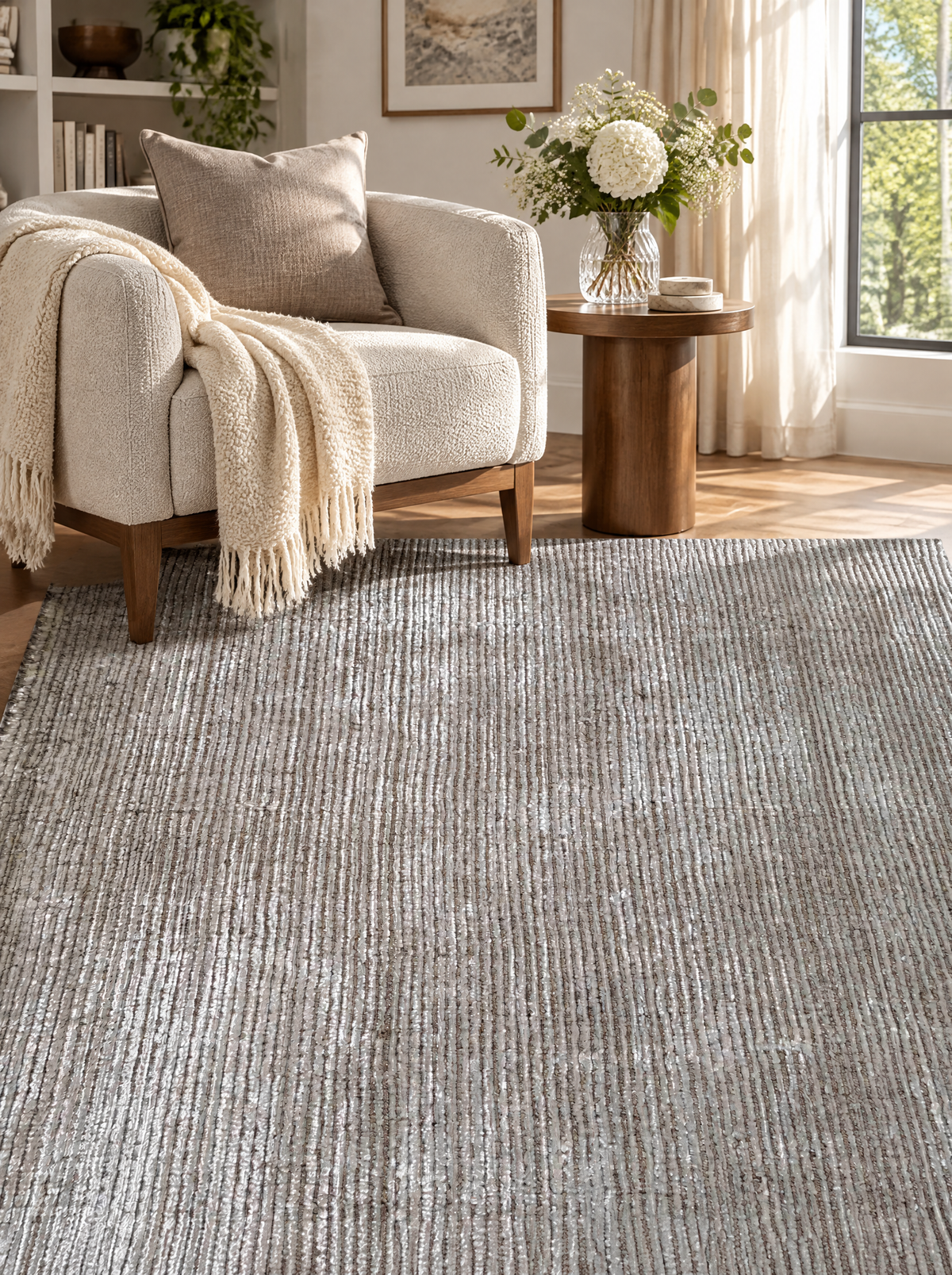 Artisan Carey Brown Style Shot — Brown and ivory textured rug beside a cream armchair and wooden side table.