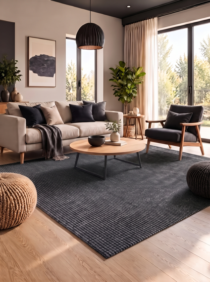 Artisan Carey Charcoal Living Room Shot — Textured charcoal rug in a modern living room with cream and charcoal seating.