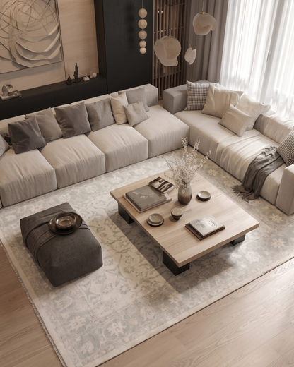 Artisan Emma Cream Overhead Shot — Overhead view of a cream rug anchoring a modern sectional seating area.