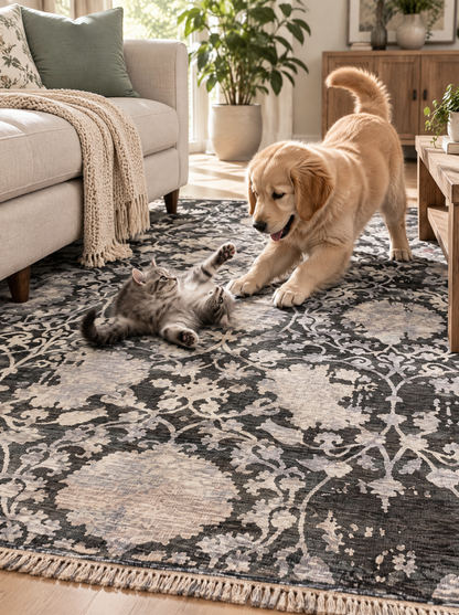 Artisan Emma Slate Living Room Shot — Slate and ivory floral rug in a bright living room with cream seating.