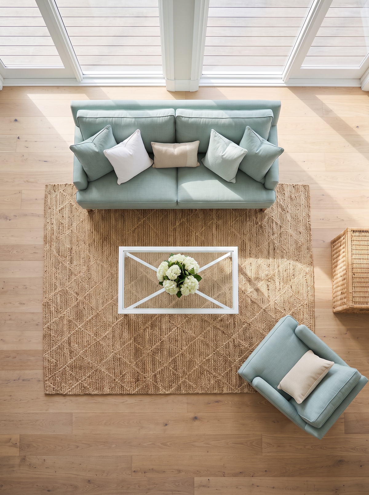 Artisan Natural Weave KM104 Natural Living Room Overhead Shot — Overhead view of a natural geometric rug with sage seating and a white coffee table.