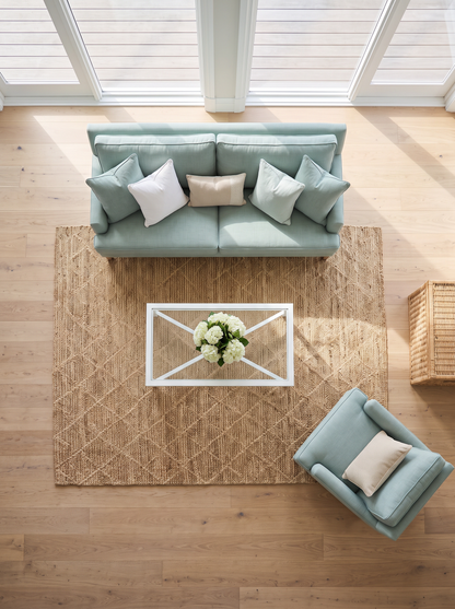 Artisan Natural Weave KM104 Natural Living Room Overhead Shot — Overhead view of a natural geometric rug with sage seating and a white coffee table.