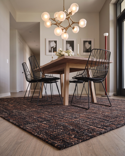 Dalyn Rugs Abruzzo AZ1 Black Dining Room Corner Shot — Textured black area rug in a modern dining room.