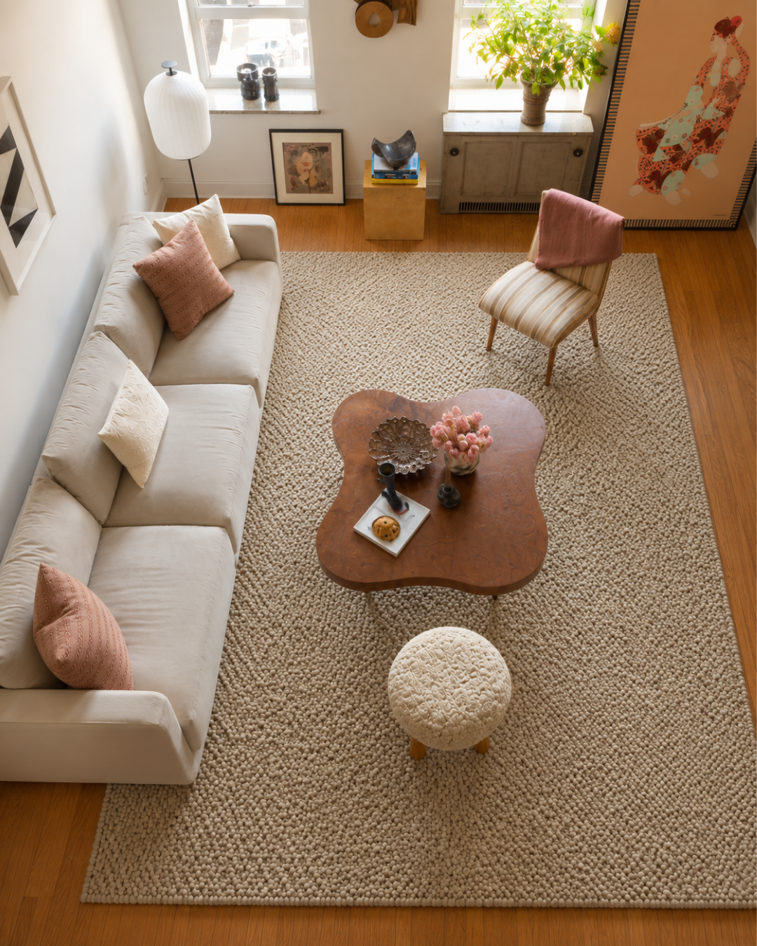 Dalyn Rugs Gorbea GR1 Latte Overhead Shot — Overhead view of a textured latte rug beneath modern living room furniture.