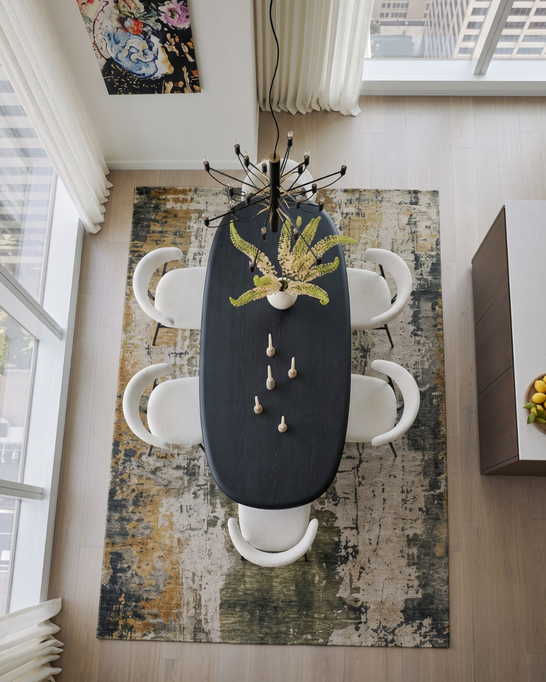 Dalyn Rugs Kochi KC14 Putty Dining Room Overhead Shot — Overhead view of a putty, olive, and gold abstract area rug beneath a black dining table.