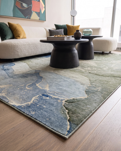 Dalyn Rugs Odyssey OY10 Sky Corner Shot — Blue and green abstract area rug in a modern living room.