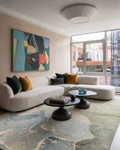Dalyn Rugs Odyssey OY10 Sky Living Room — Sky blue and green abstract rug styled in a contemporary living room.