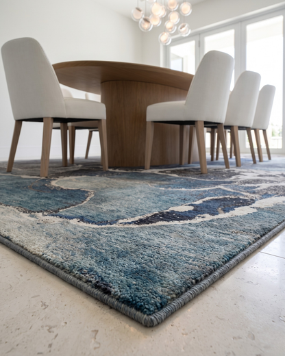 OY3 Blue Corner: Blue abstract rug beneath a dining table.