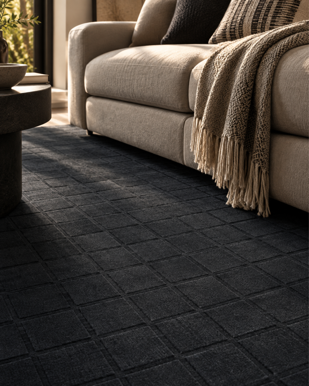 Momeni Rugs Contour CON-2 Navy Style Shot — Navy textured geometric area rug close-up beside a neutral sofa.