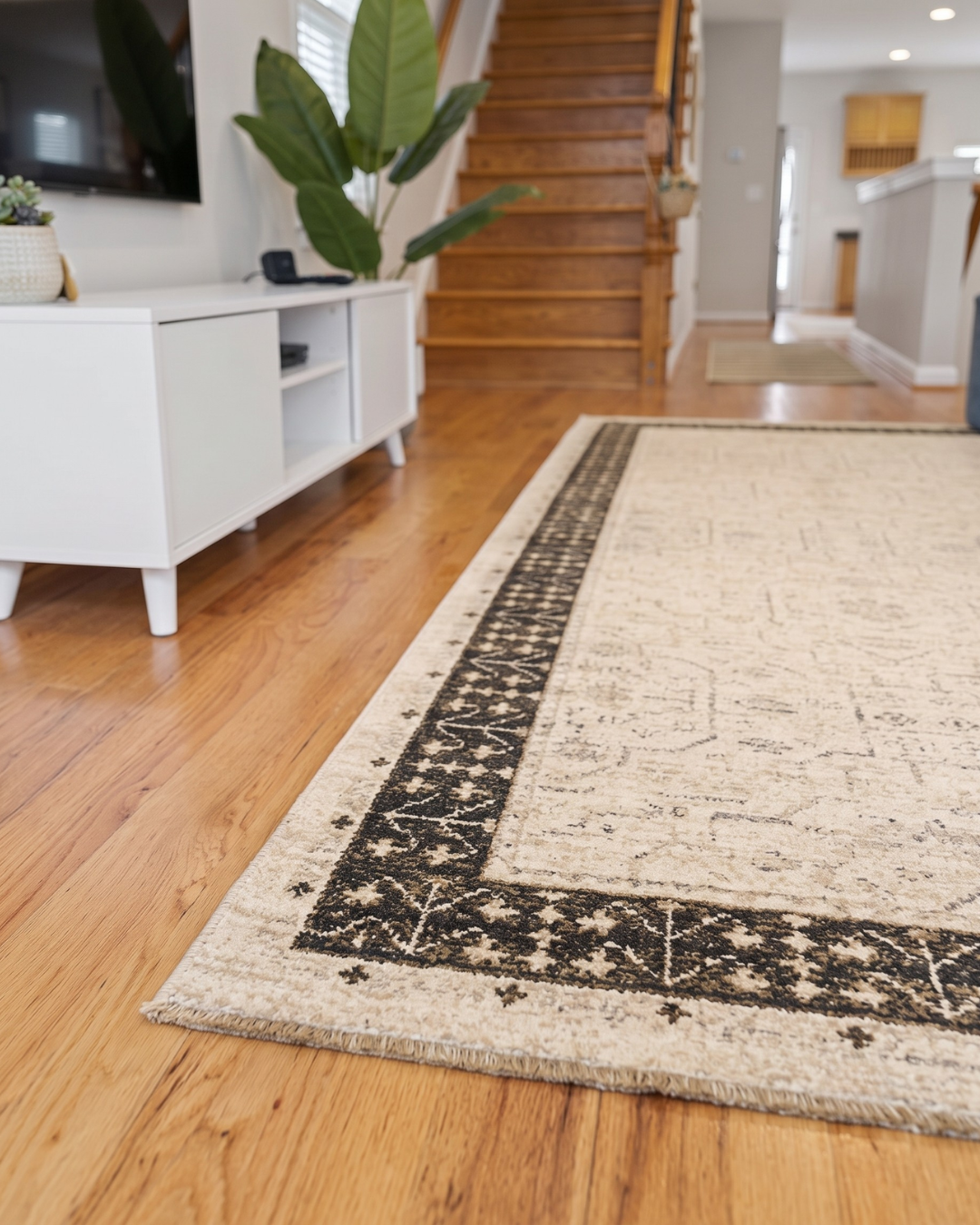 Oriental Weavers Acacia ACA02 Beige Brown rug corner detail with distressed border on hardwood floor