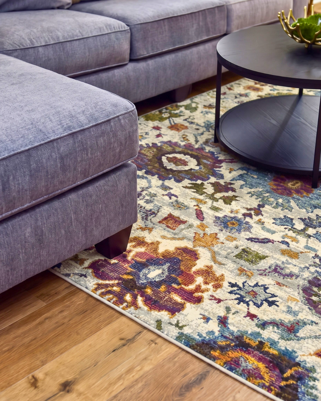 Oriental Weavers Andorra 7129A Stone Multi colorful floral area rug close-up with ivory, blue and plum accents.