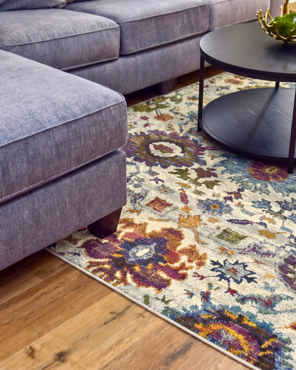 Oriental Weavers Andorra 7129A Stone Multi colorful floral area rug close-up with ivory, blue and plum accents.