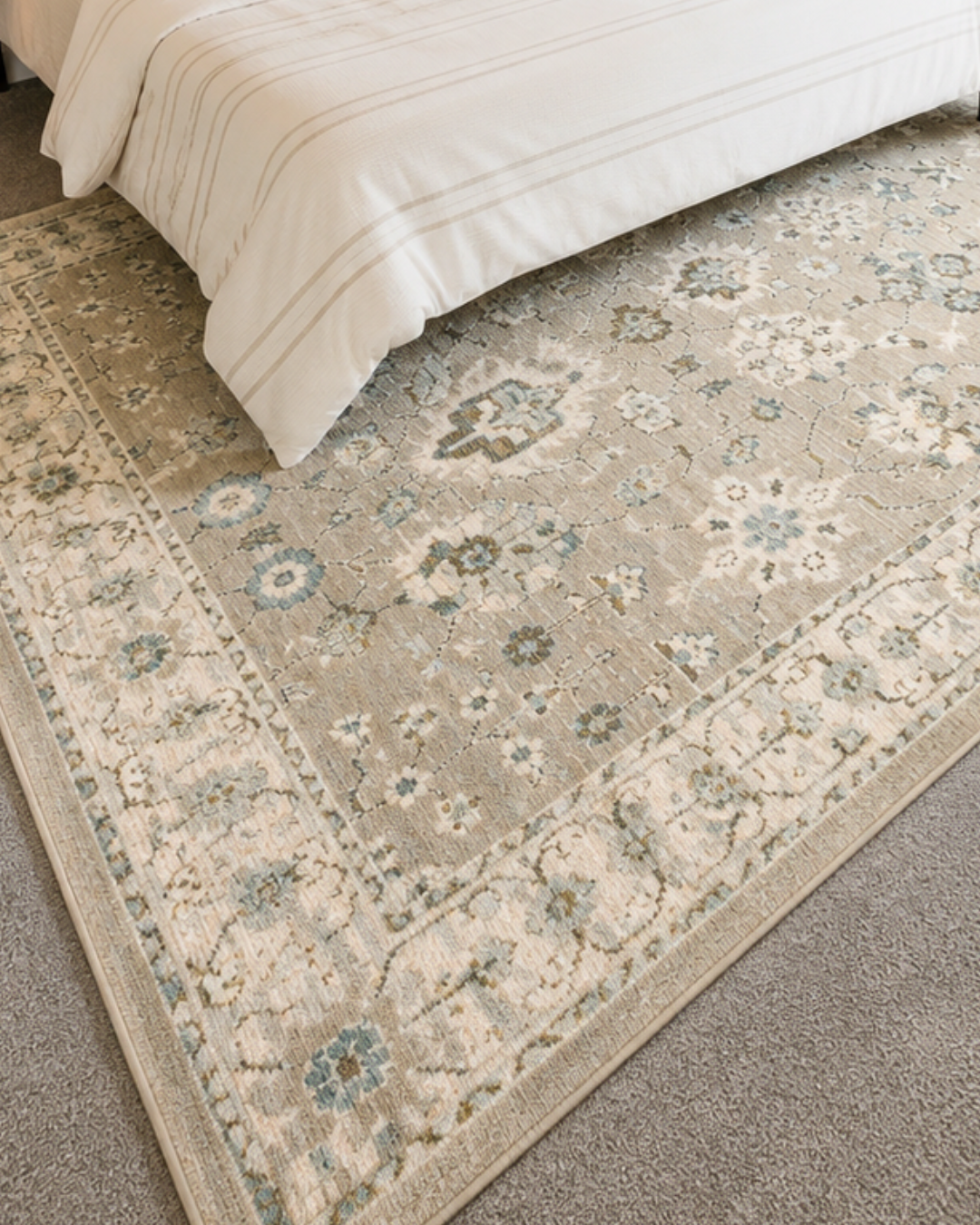 Oriental Weavers Andorra 8930L Beige Ivory vintage floral rug close-up in a bedroom.