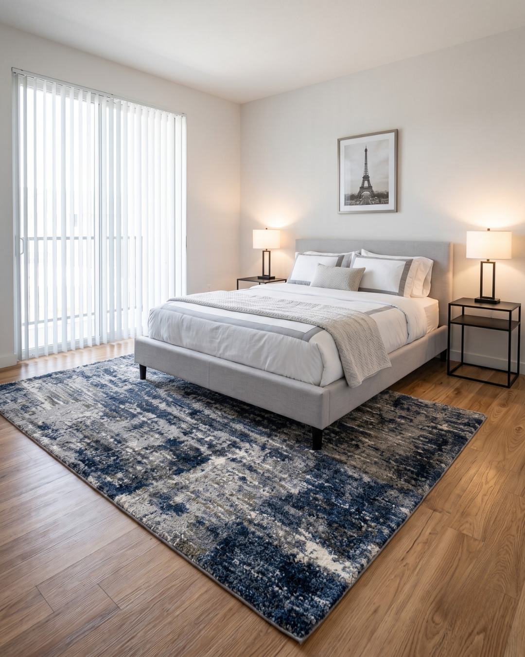Oriental Weavers Aspen 2061L Grey Blue Bedroom Shot — Grey and blue abstract area rug styled in a bright contemporary bedroom.