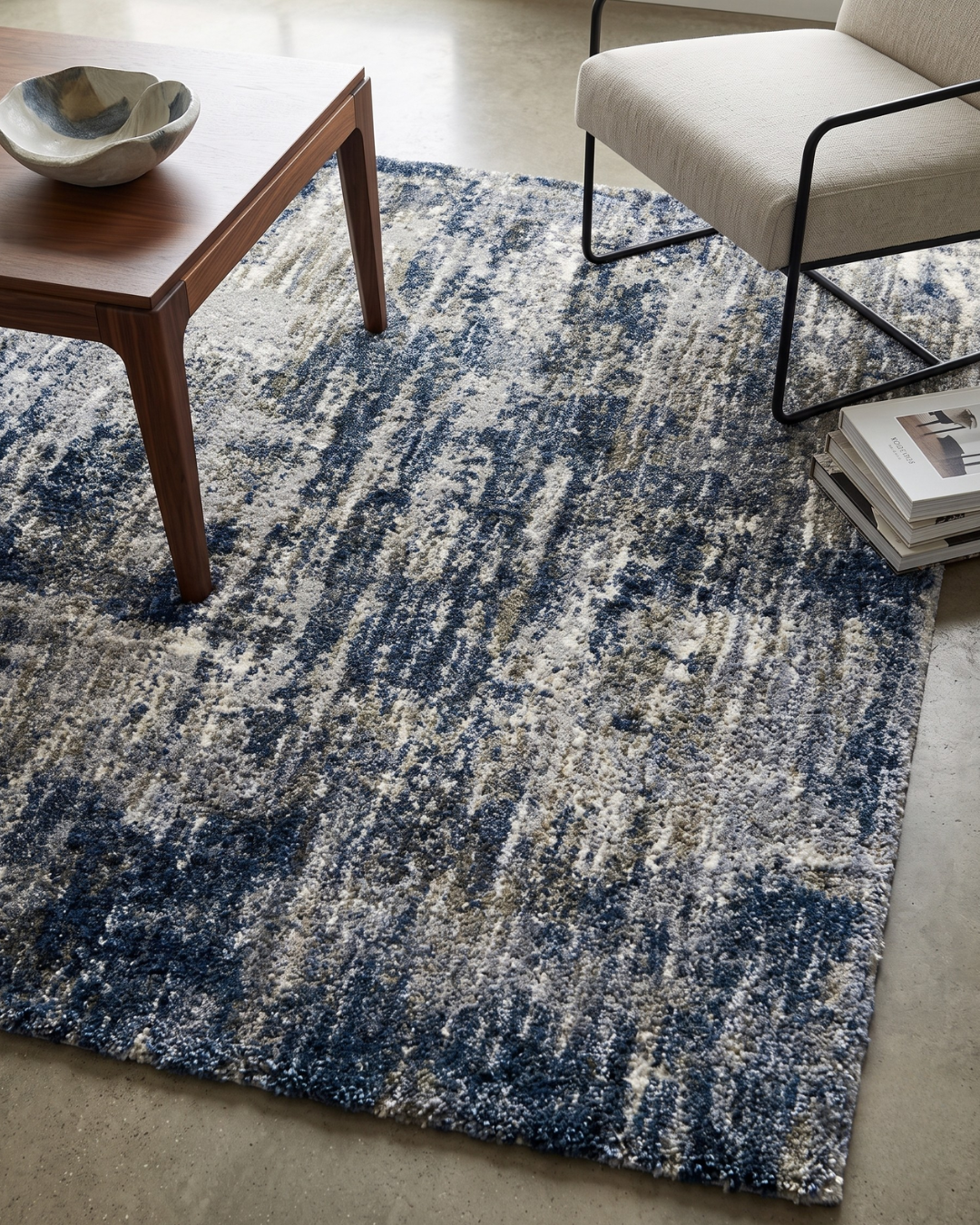 Oriental Weavers Aspen 2061L Grey Blue Style Shot — Grey and blue abstract rug styled with a modern wood coffee table and accent chair.