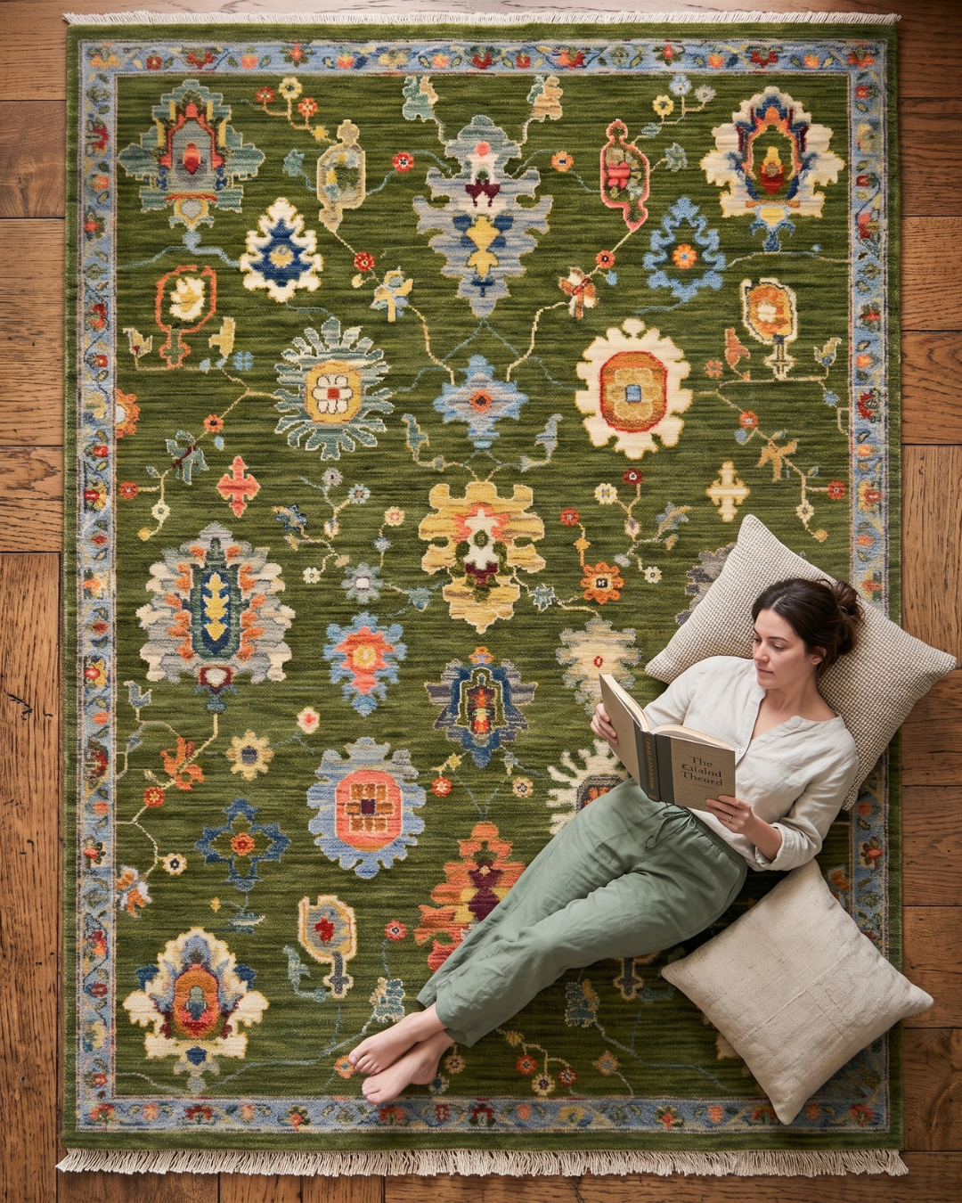 Oriental Weavers Lucca 2863E Green Multi floral rug style shot with woman reading